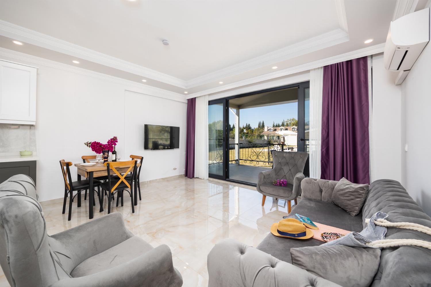 Annex: open-plan living room with sofa, dining area, kitchen, A/C, WiFi internet, and satellite TV