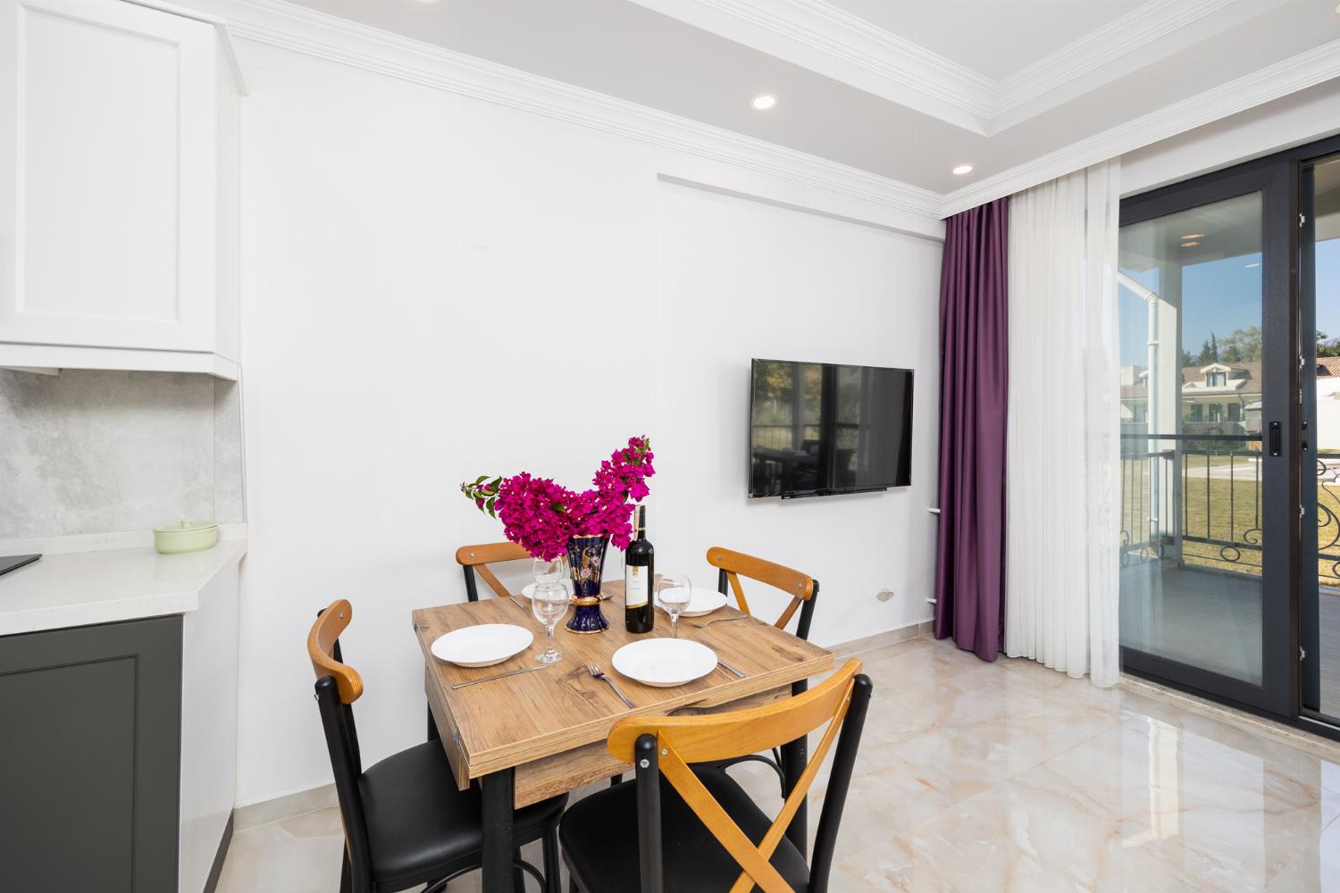 Annex: open-plan living room with sofa, dining area, kitchen, A/C, WiFi internet, and satellite TV