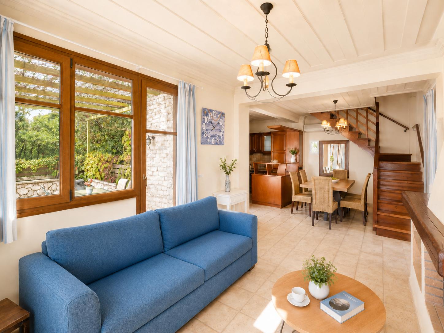 Open-plan living room with sofa, dining area, kitchen, WiFi internet, and satellite TV