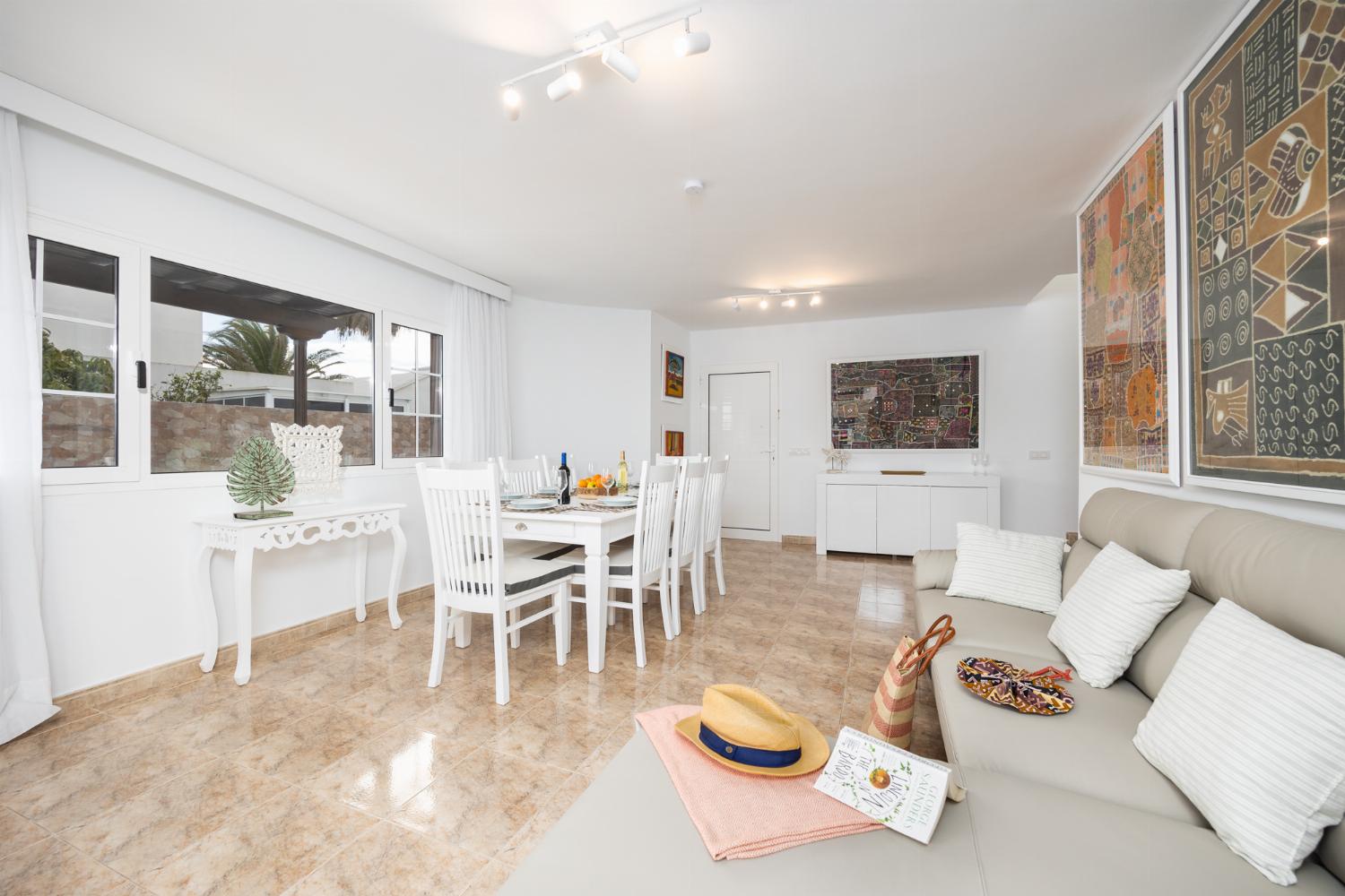 Living room with sofa, dining area, A/C, WiFi internet, and satellite TV