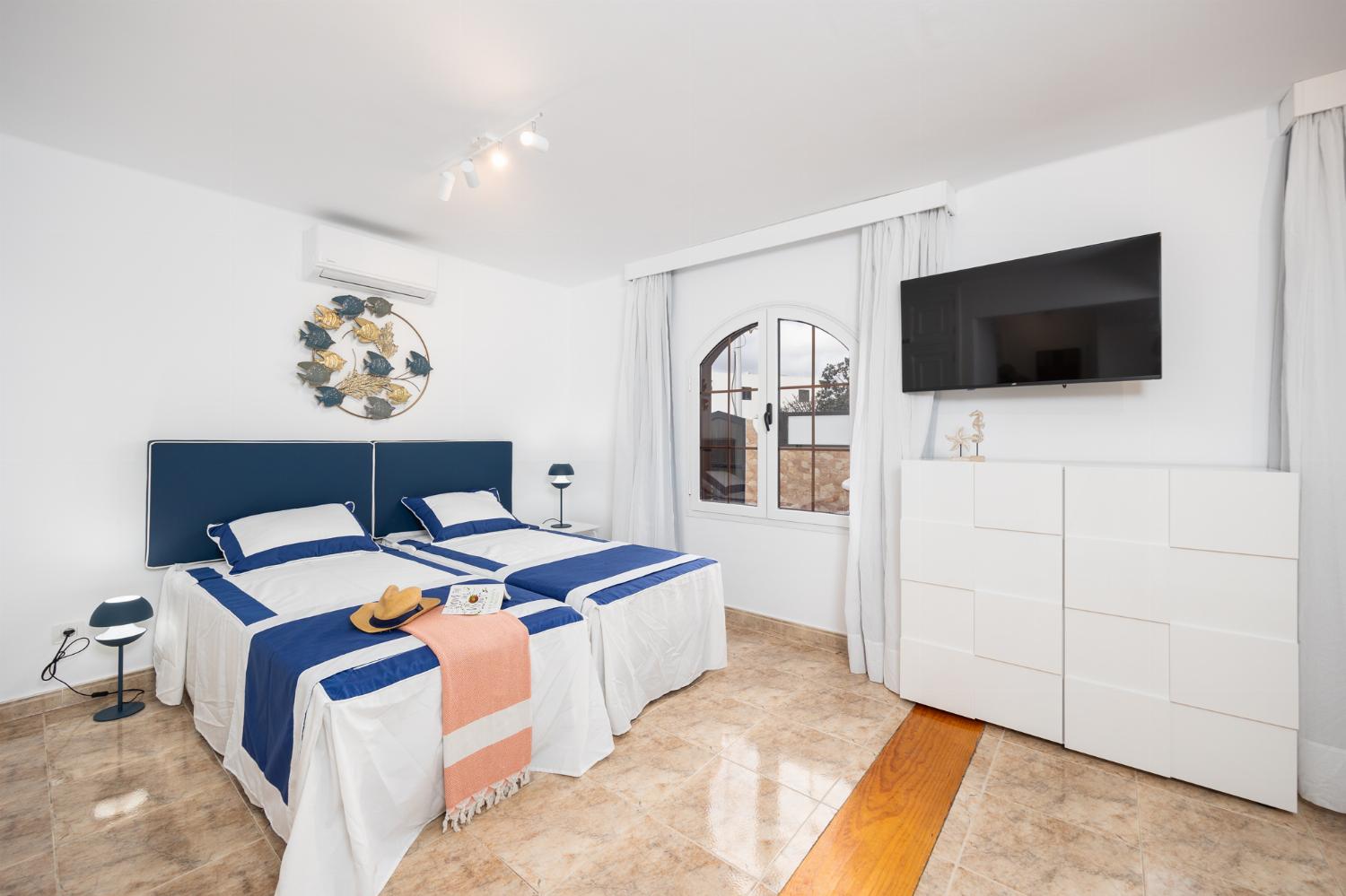 Twin bedroom with en suite bathroom and A/C