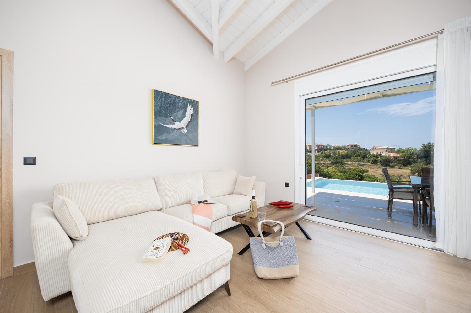 Open-plan living room with sofa, dining area, kitchen, A/C, WiFi internet, and satellite TV