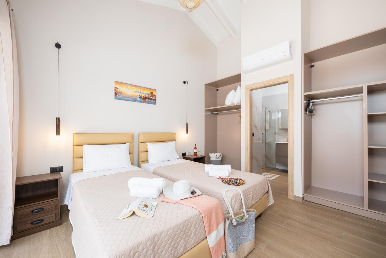 Twin bedroom with en suite bathroom and A/C