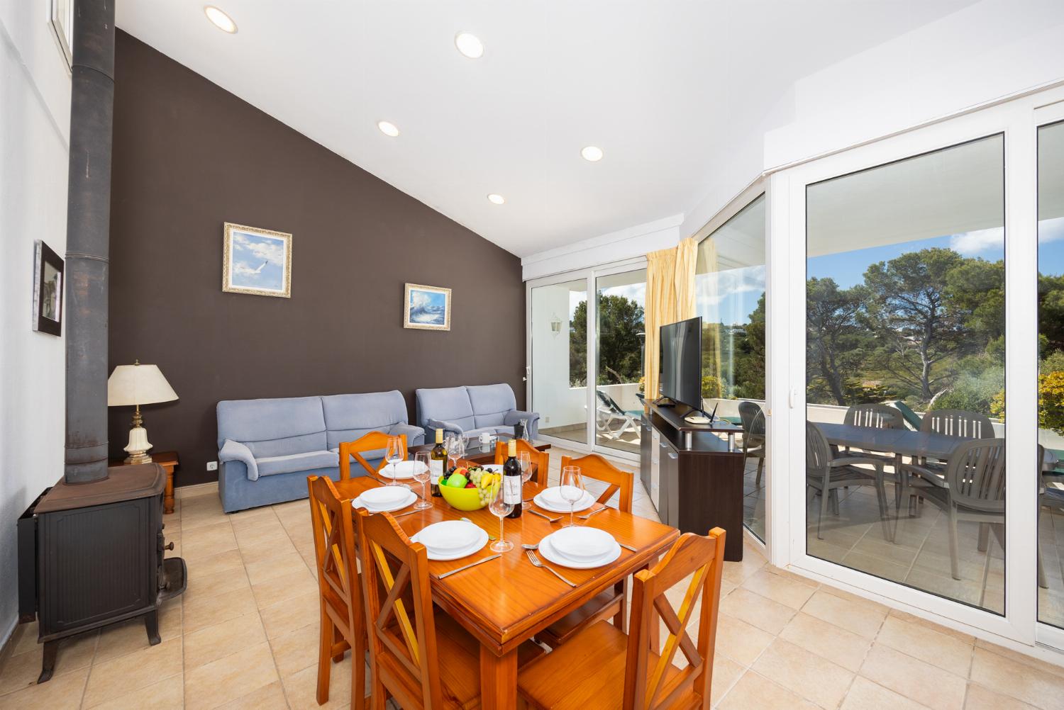 Living room with sofas, dining area, ornamental fireplace, WiFi internet, and satellite TV
