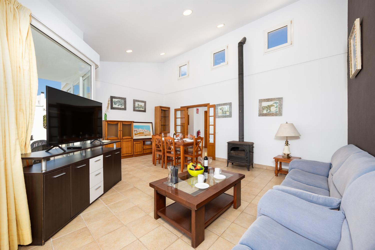 Living room with sofas, dining area, ornamental fireplace, WiFi internet, and satellite TV