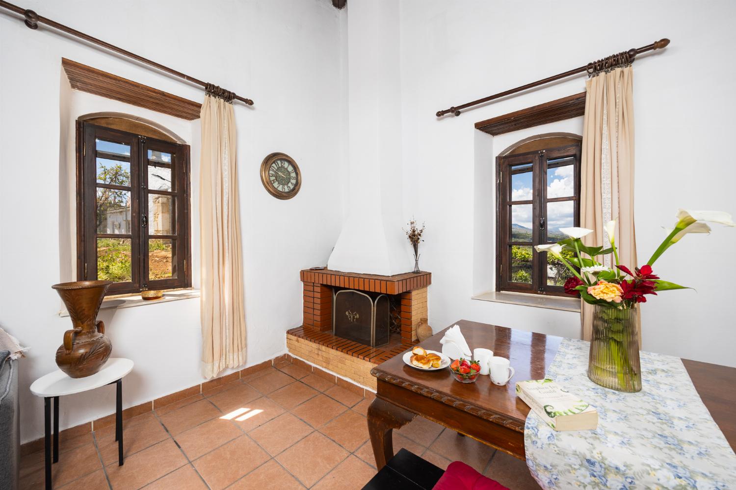 Open-plan living room with sofa, dining area, kitchen, ornamental fireplace, WiFi internet, and satellite TV