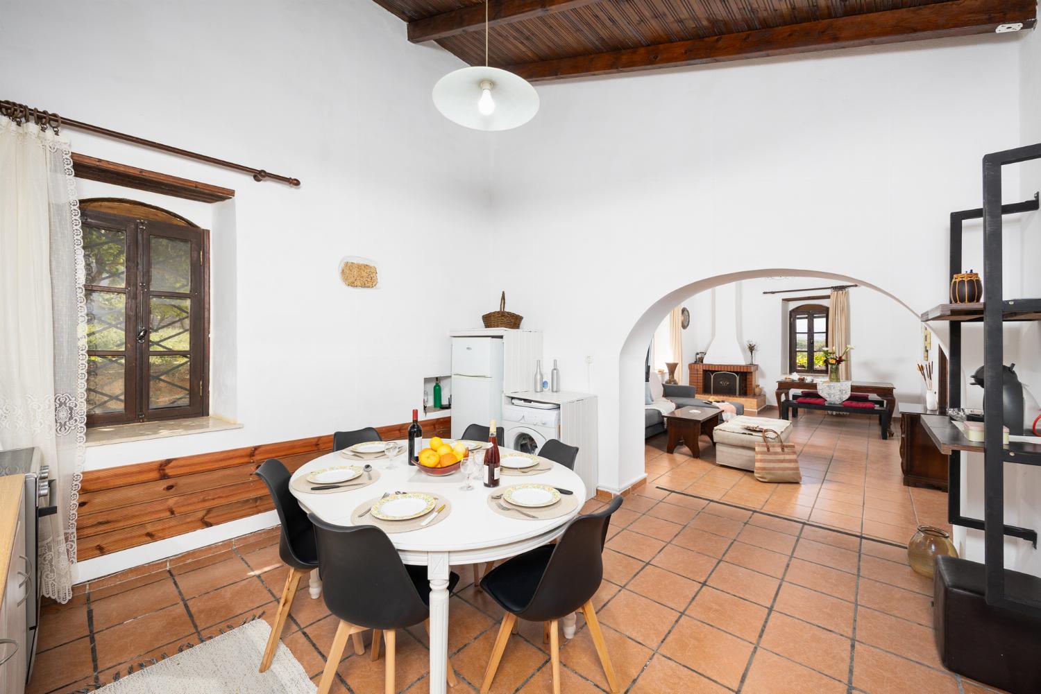 Open-plan living room with sofa, dining area, kitchen, ornamental fireplace, WiFi internet, and satellite TV