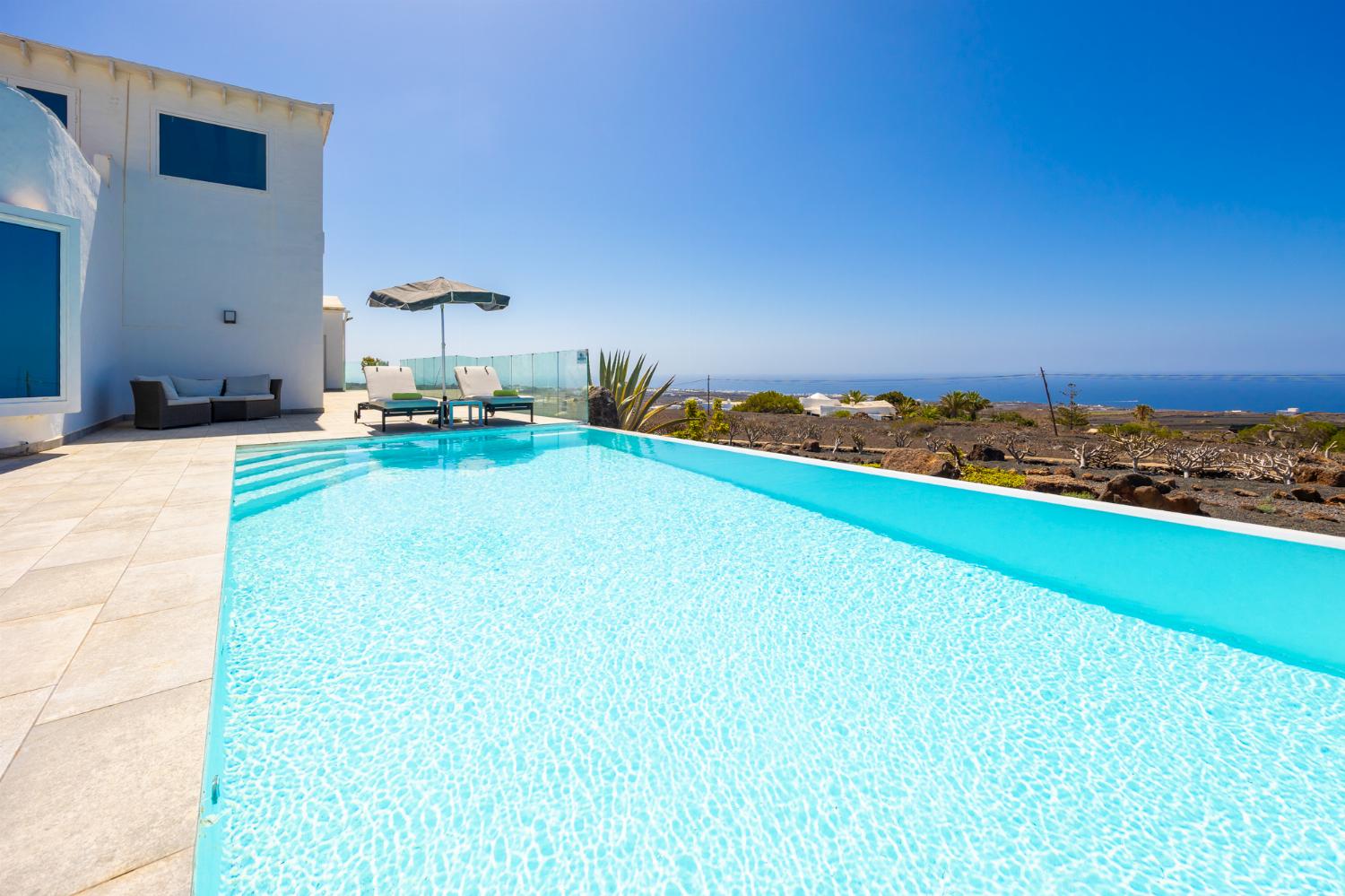 Private pool, terrace, and garden with panoramic sea views