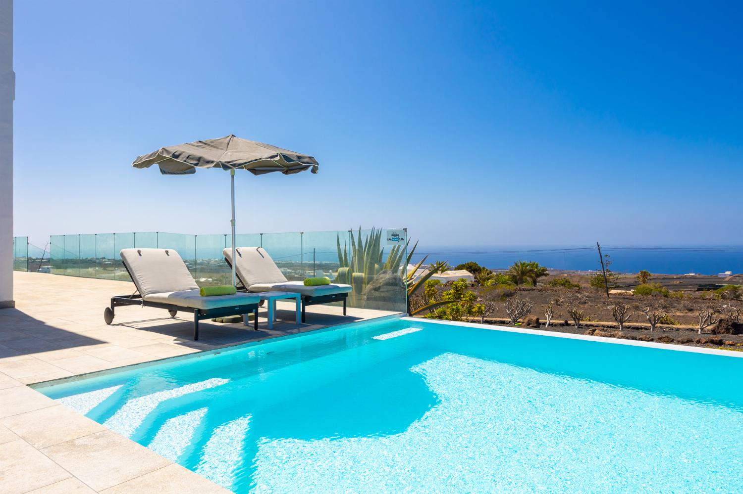 Private pool, terrace, and garden with panoramic sea views