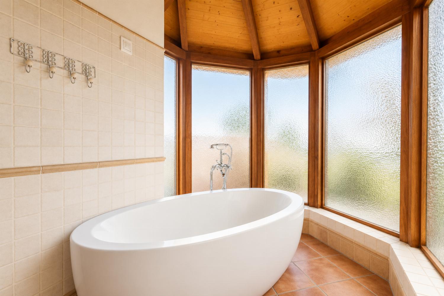 En suite bathroom with bath and shower