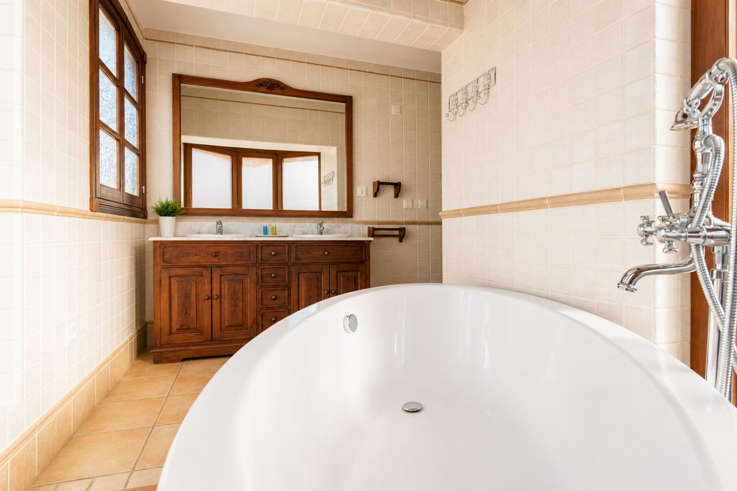En suite bathroom with bath and shower