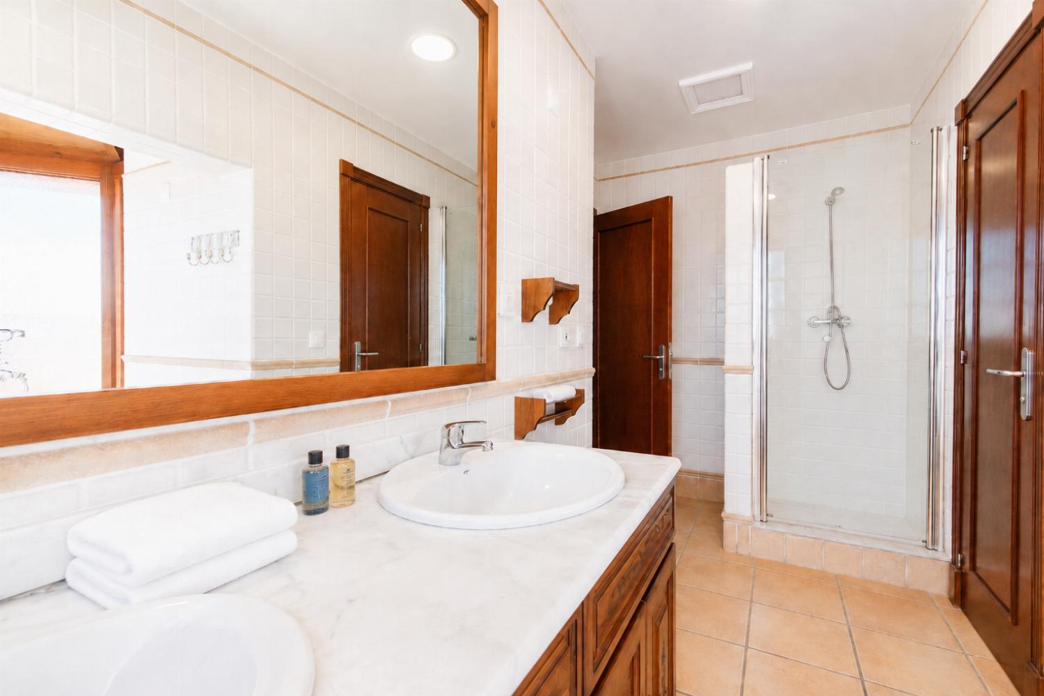 En suite bathroom with bath and shower