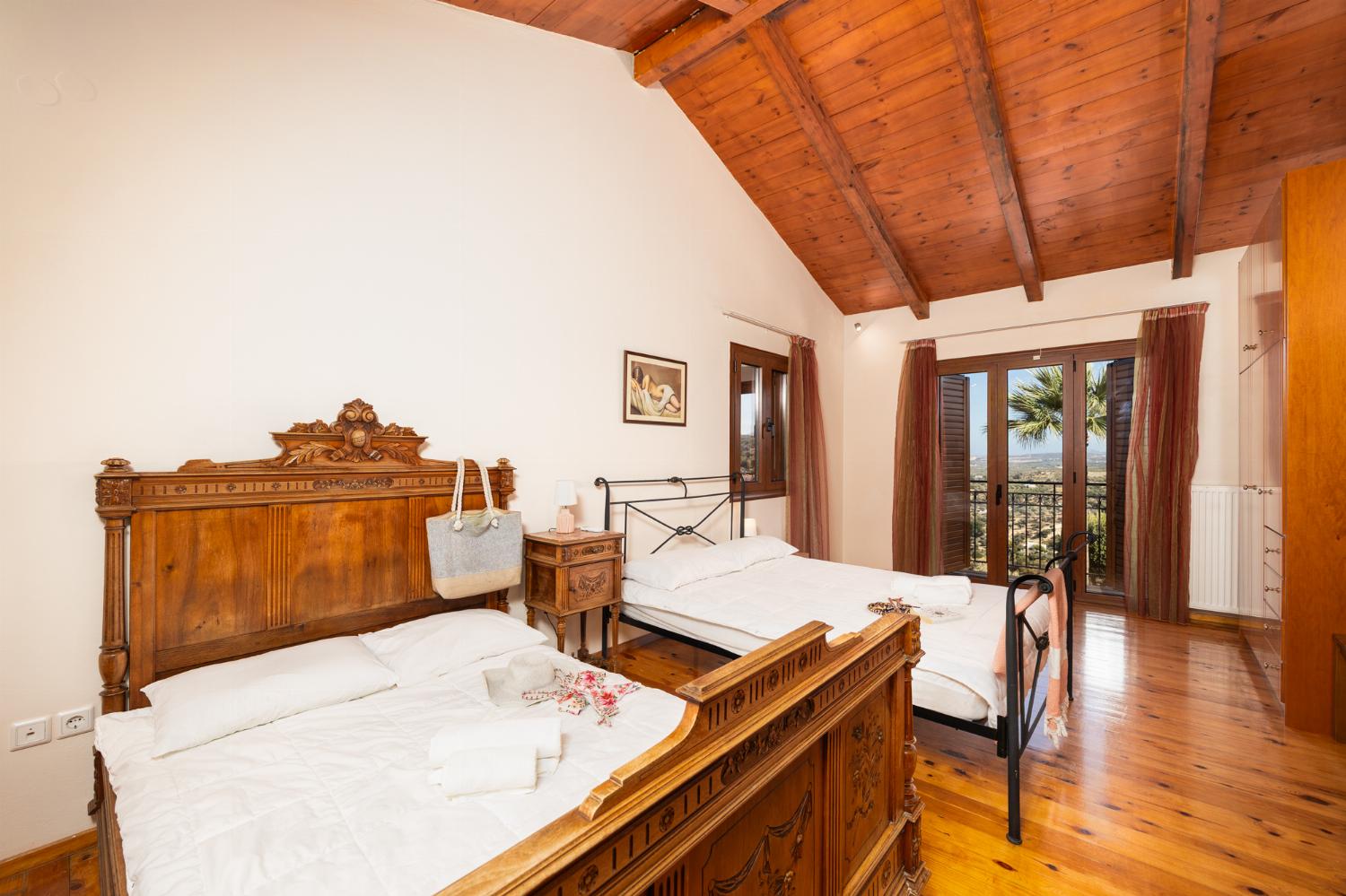 Bedroom with two double beds, en suite bathroom, and A/C