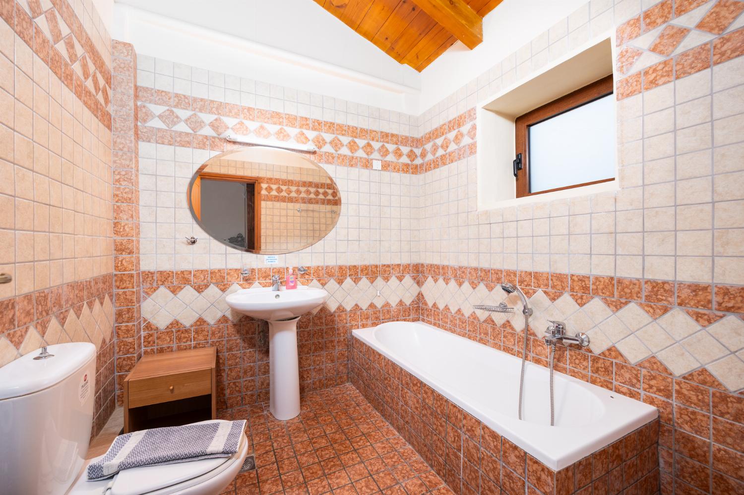 En suite bathroom with bath and shower