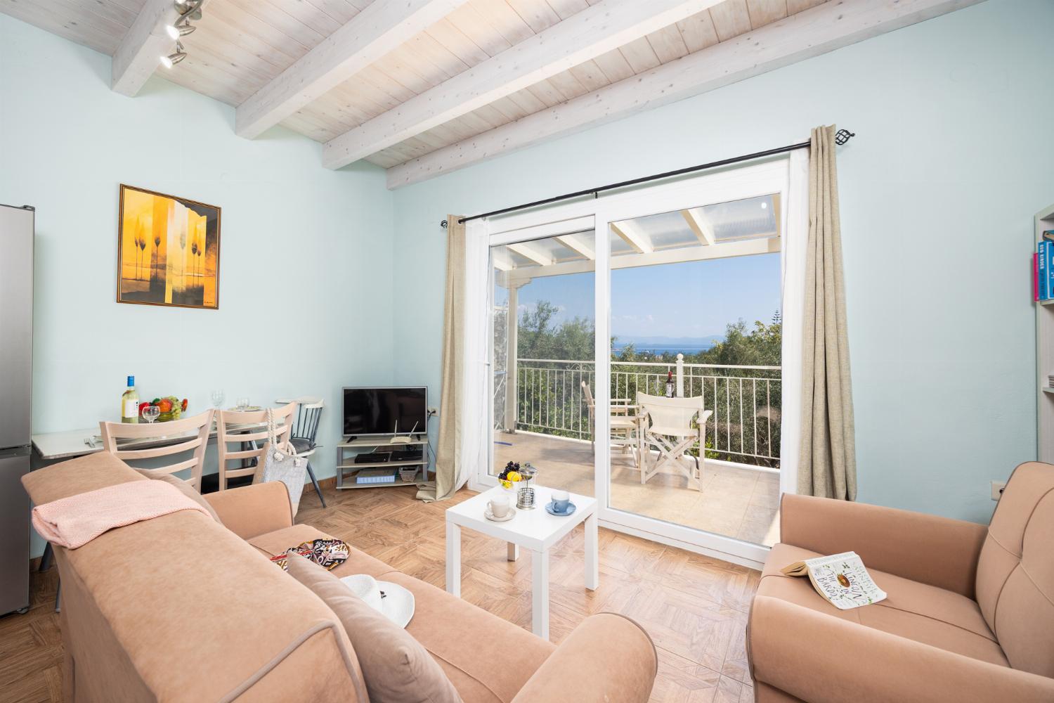 Open-plan living room with sofas, dining area, kitchen, A/C, WiFi internet, satellite TV, and sea views