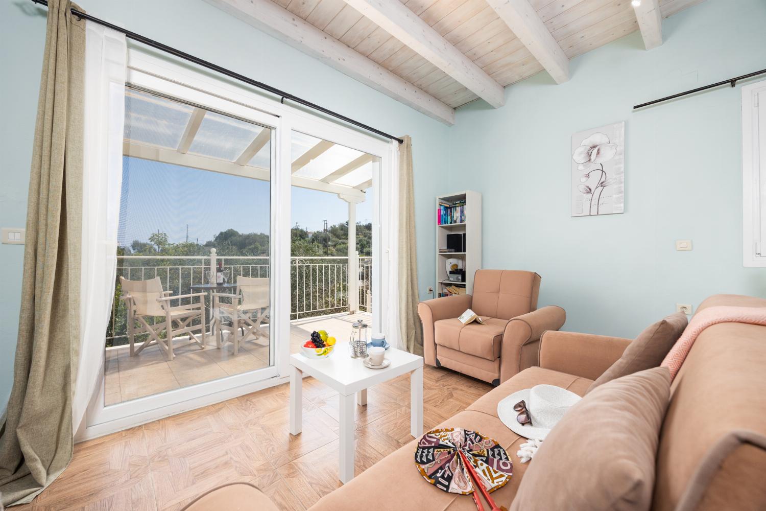 Open-plan living room with sofas, dining area, kitchen, A/C, WiFi internet, satellite TV, and sea views