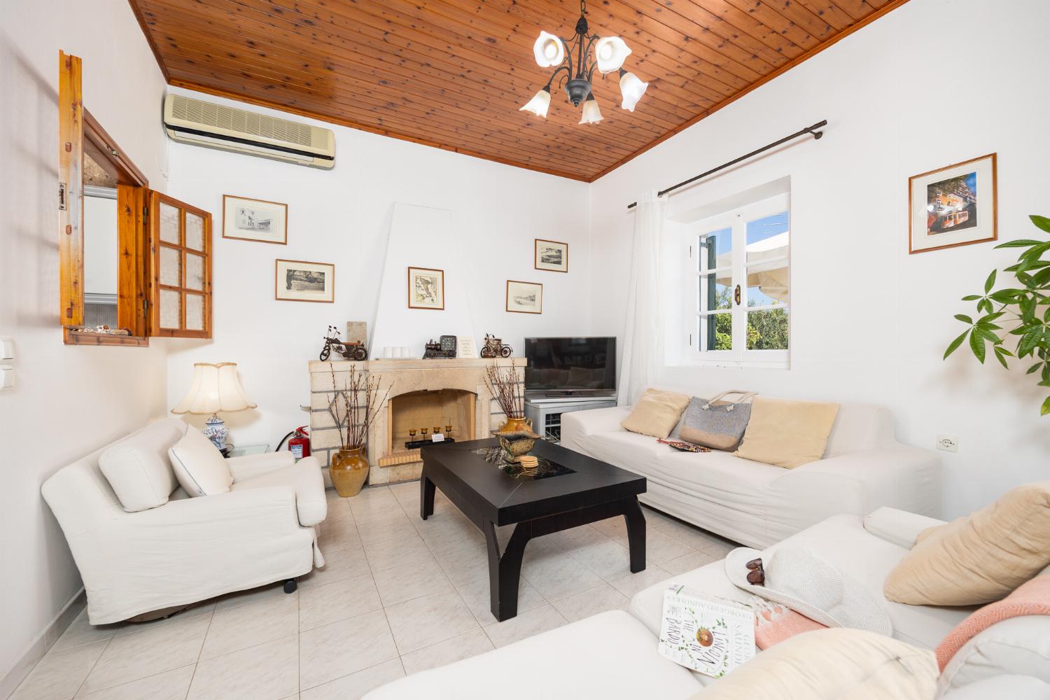 Living room with sofas, dining area, A/C, WiFi internet, and satellite TV