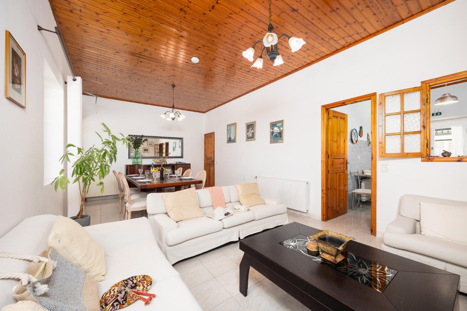 Living room with sofas, dining area, A/C, WiFi internet, and satellite TV