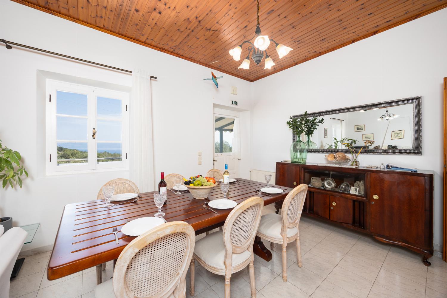 Living room with sofas, dining area, A/C, WiFi internet, and satellite TV
