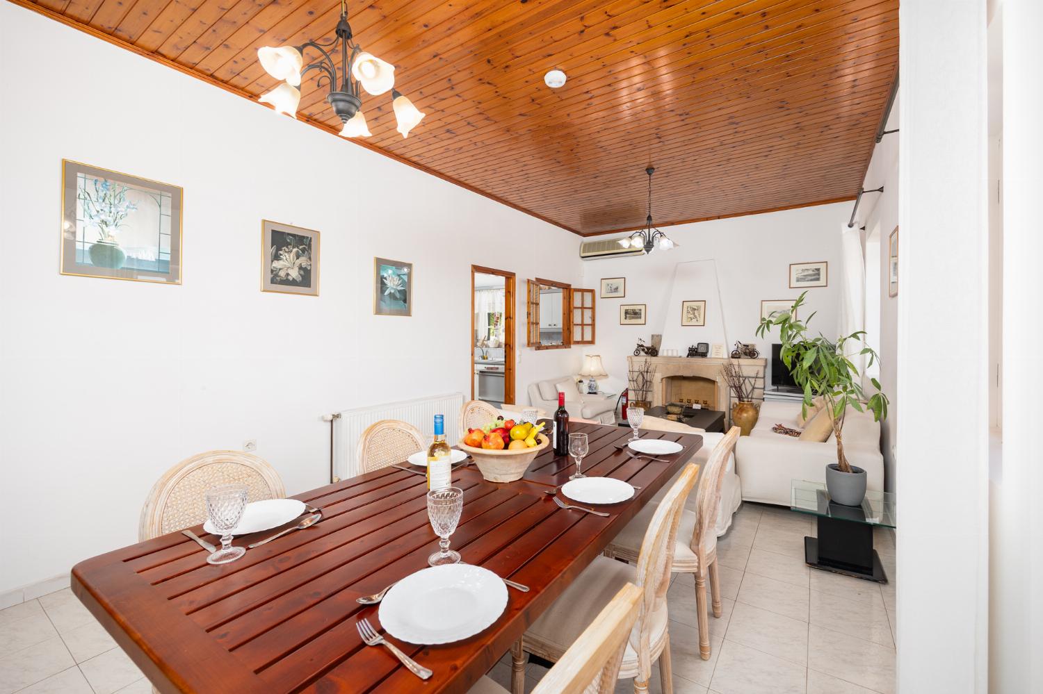 Living room with sofas, dining area, A/C, WiFi internet, and satellite TV