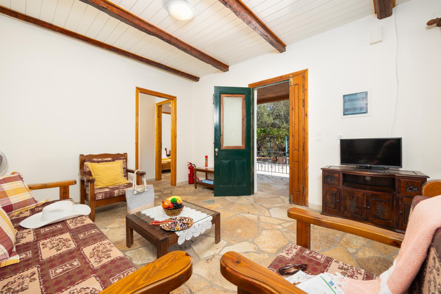 Open-plan living room with sofa, dining area, kitchen, WiFi internet, and satellite TV