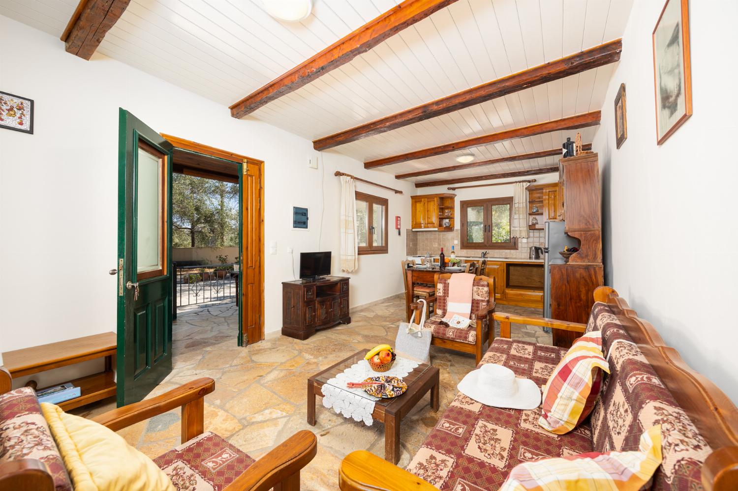 Open-plan living room with sofa, dining area, kitchen, WiFi internet, and satellite TV