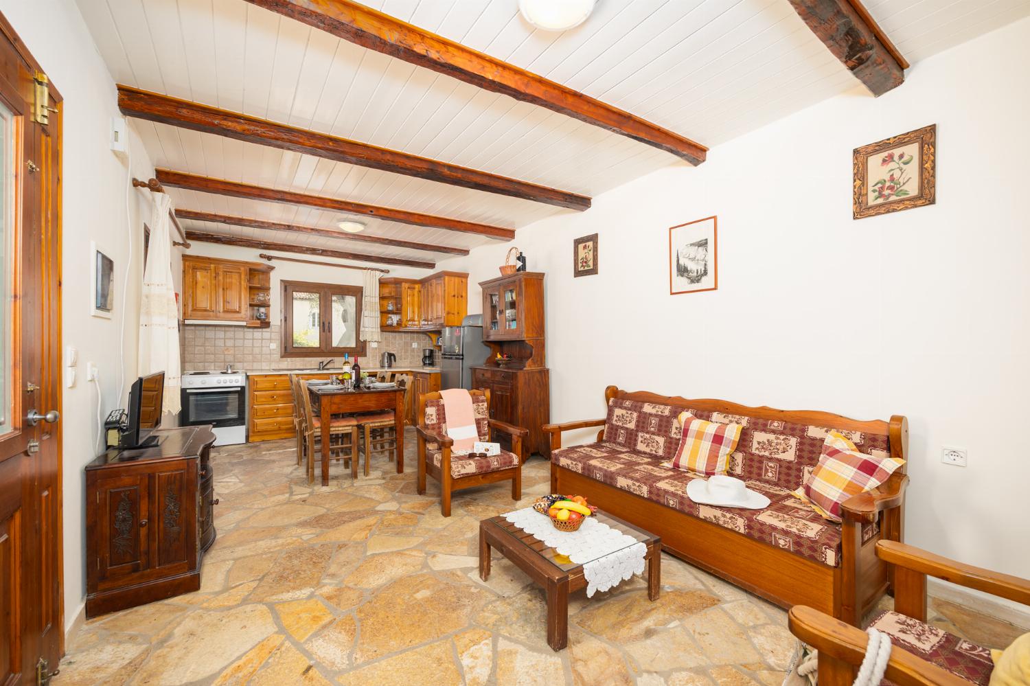 Open-plan living room with sofa, dining area, kitchen, WiFi internet, and satellite TV