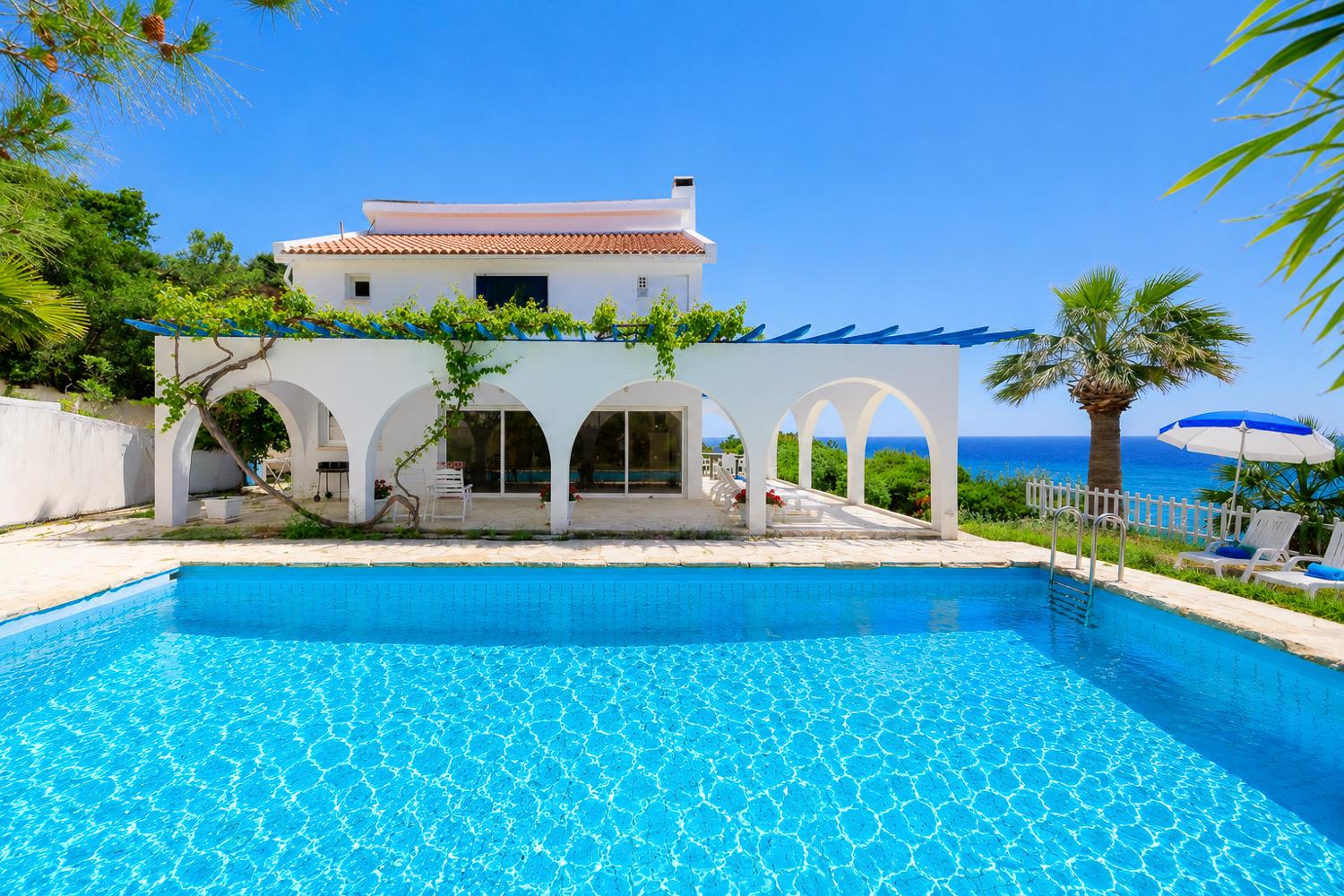 ,Seafront villa with a large private pool, arched terrace, and beautiful Mediterranean views.