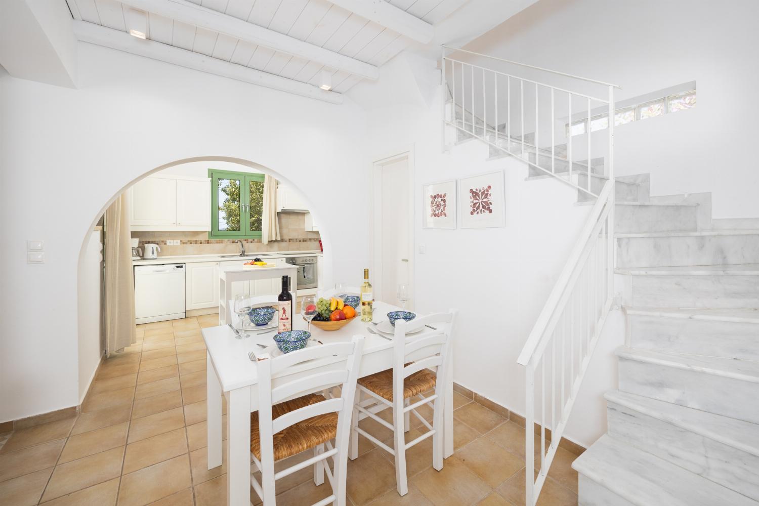 Open-plan living room with sofa, dining area, kitchen, A/C, WiFi internet, and satellite TV