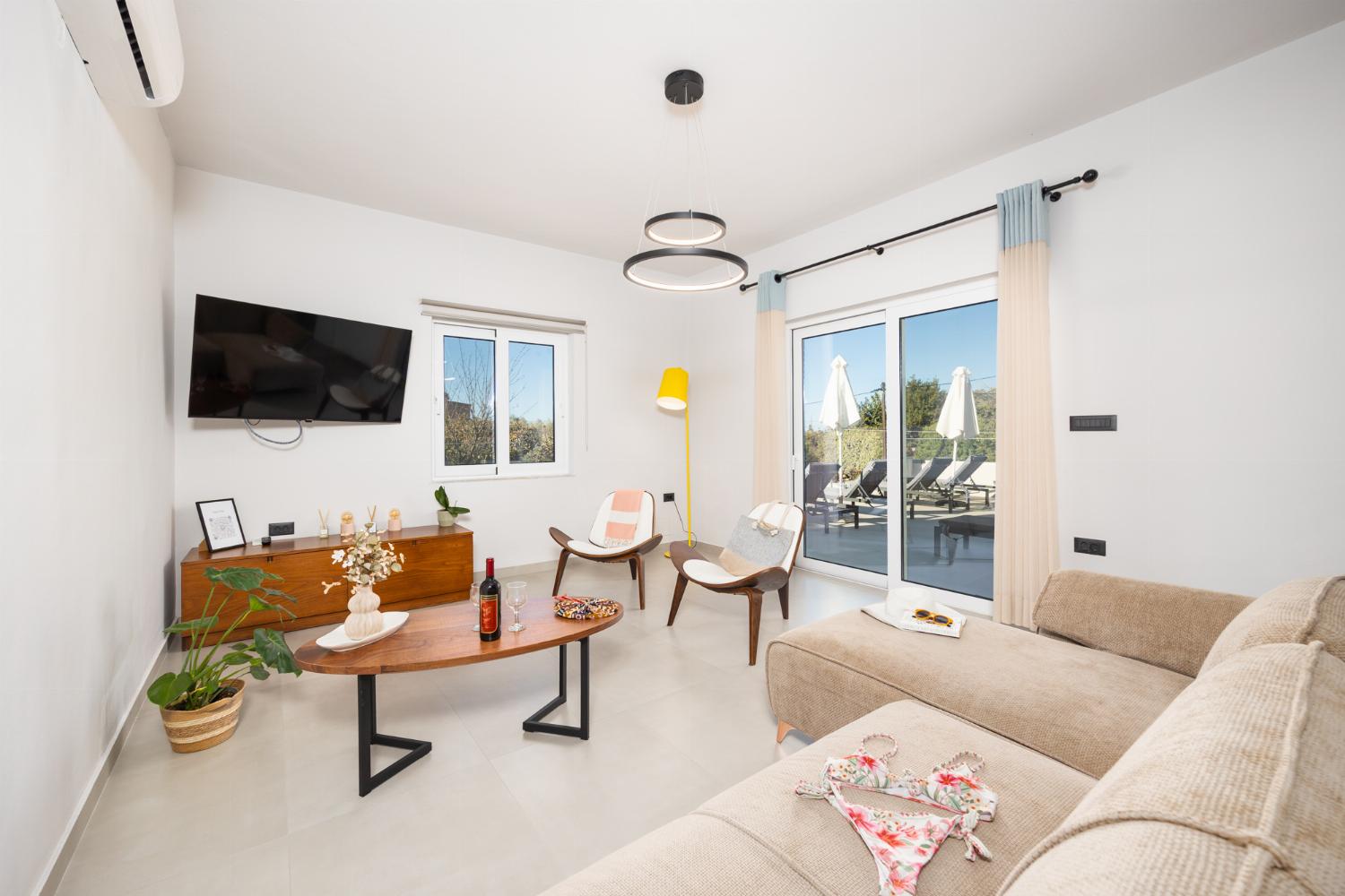 Living room with sofa, dining area, A/C, WiFi internet, and satellite TV