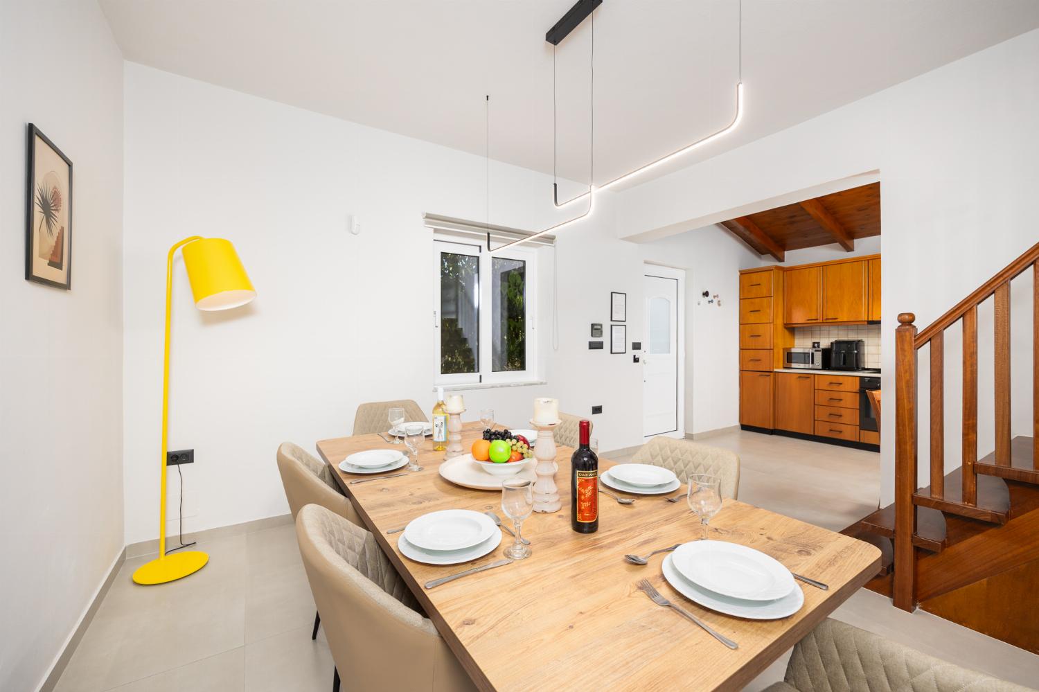 Living room with sofa, dining area, A/C, WiFi internet, and satellite TV