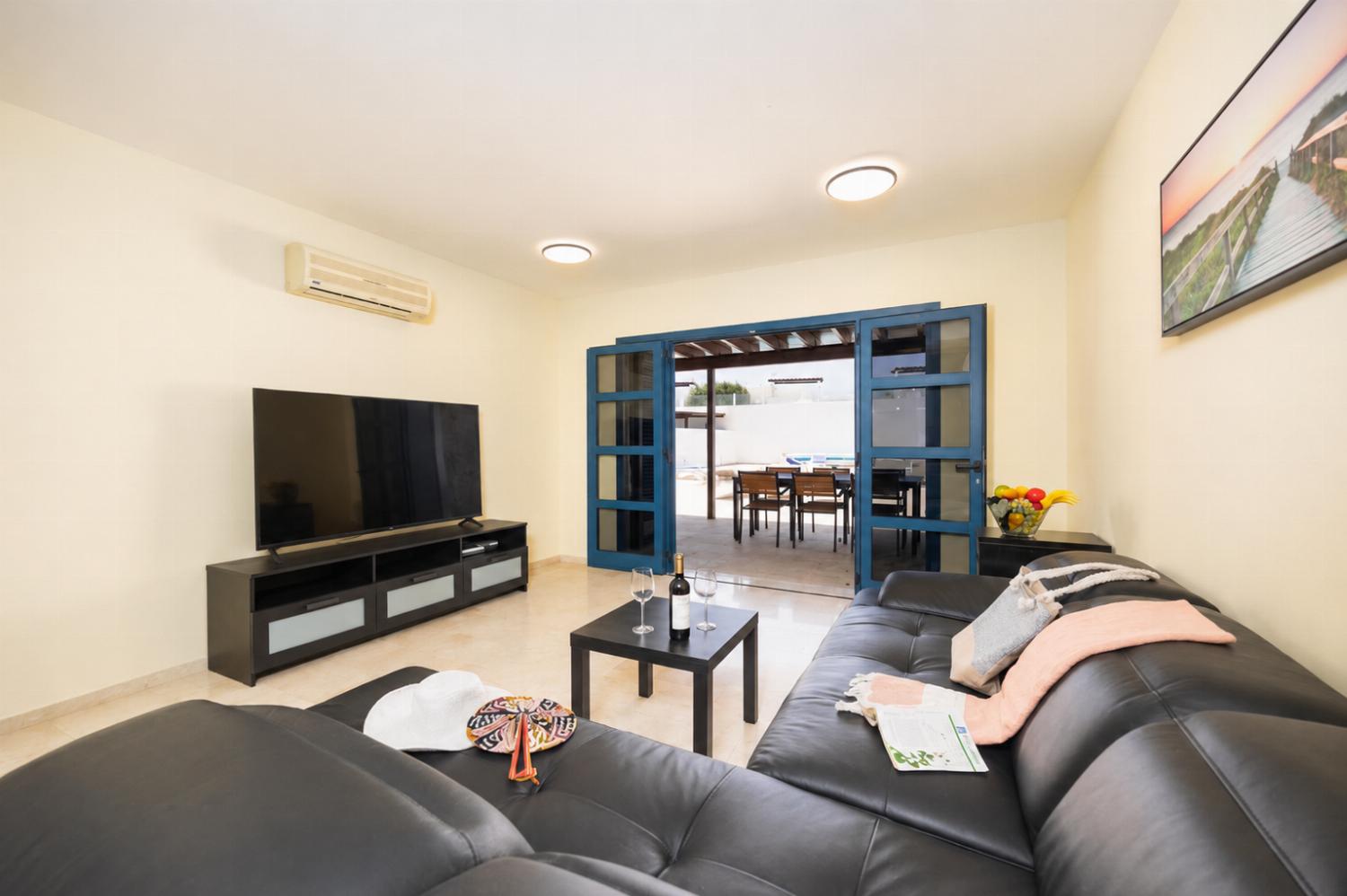 Living room with sofa, A/C, WiFi internet, and satellite TV
