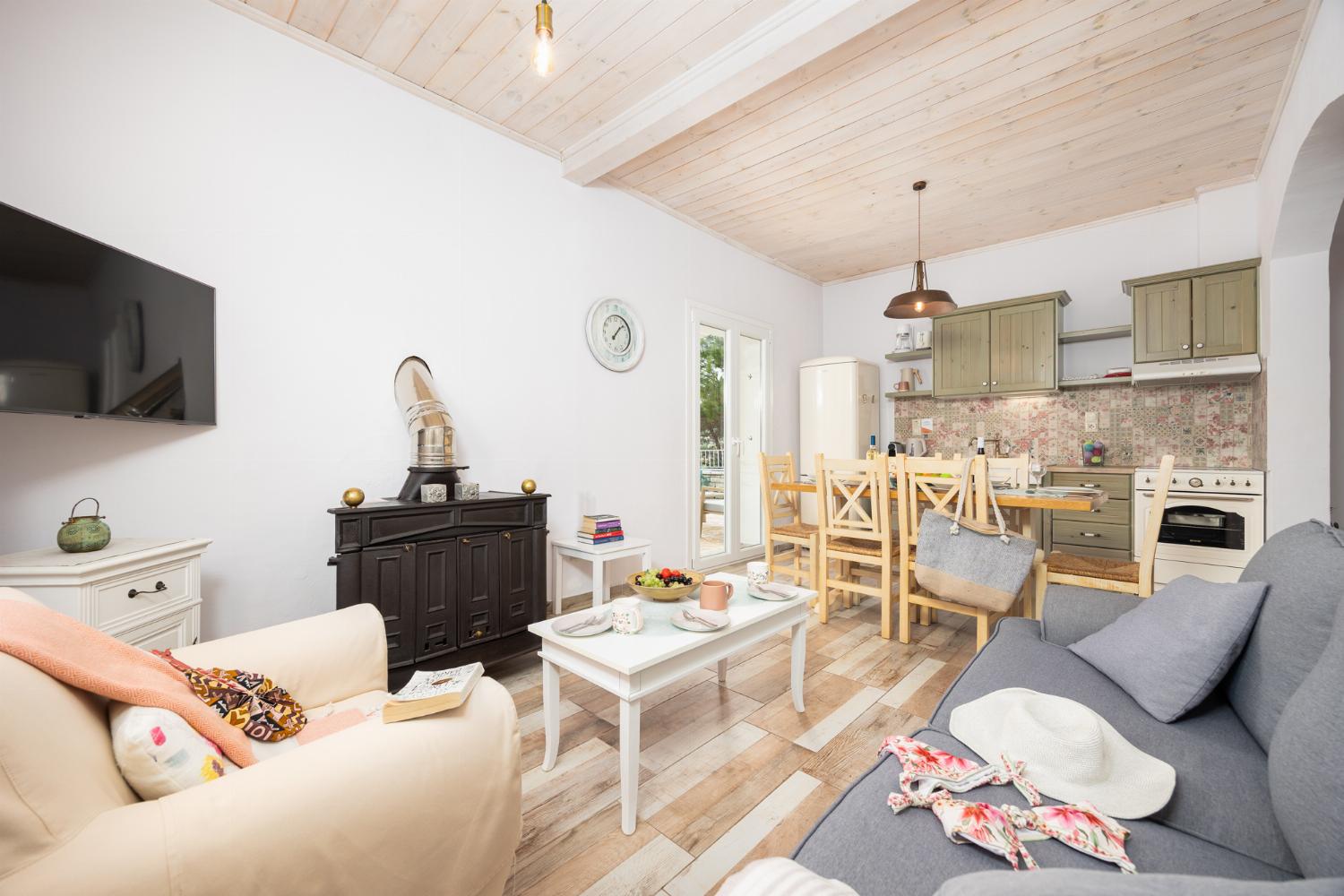 Open-plan living room with sofa, dining area, kitchen, WiFi internet, and satellite TV