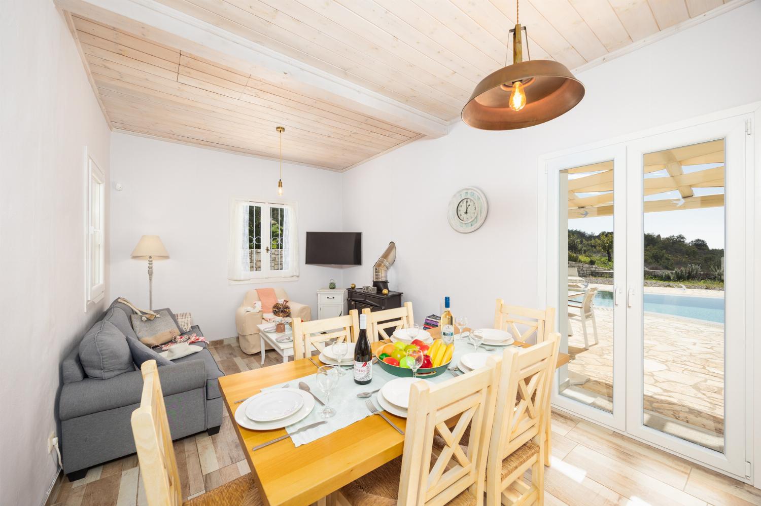 Open-plan living room with sofa, dining area, kitchen, WiFi internet, and satellite TV