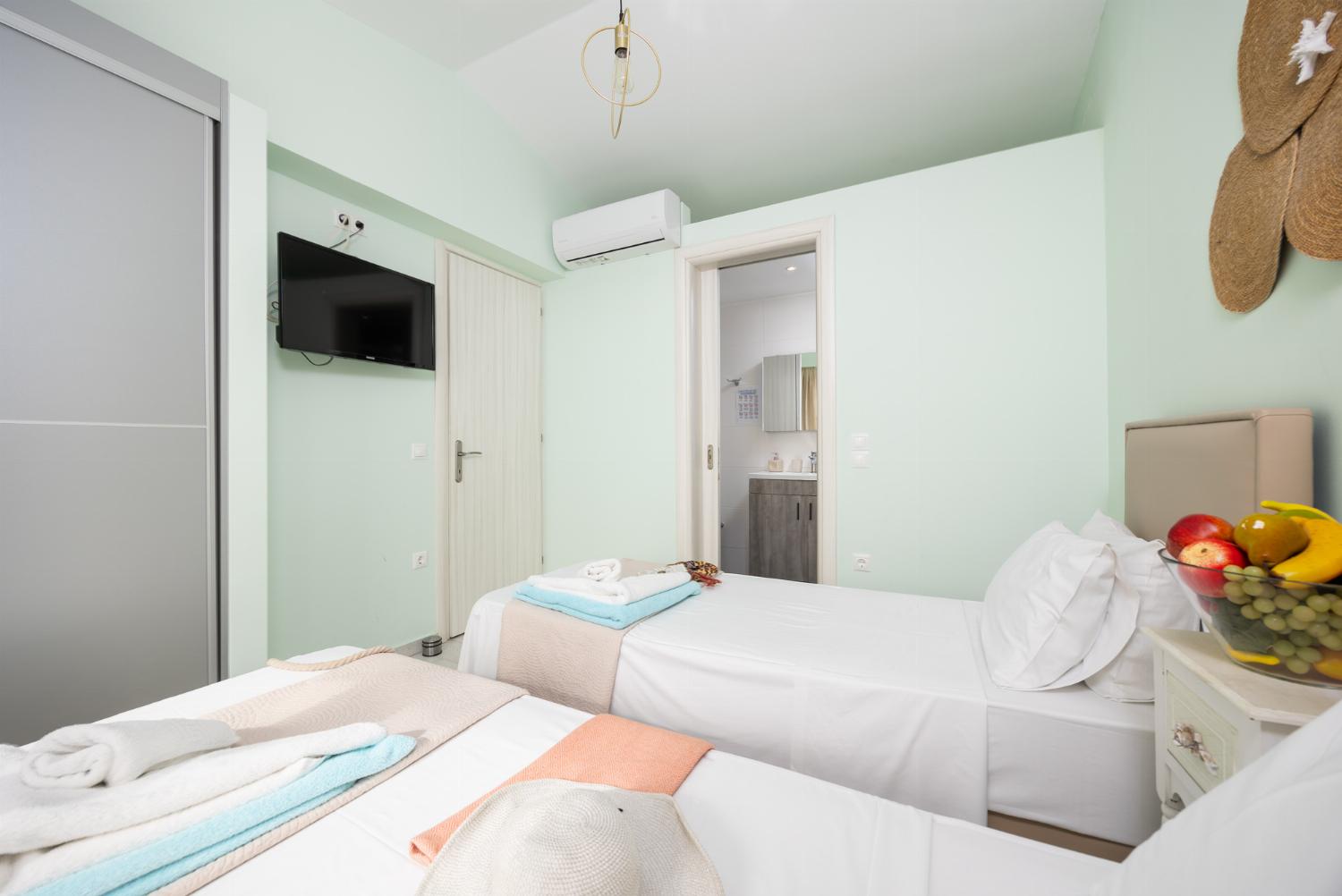 Twin bedroom with en suite bathroom and A/C