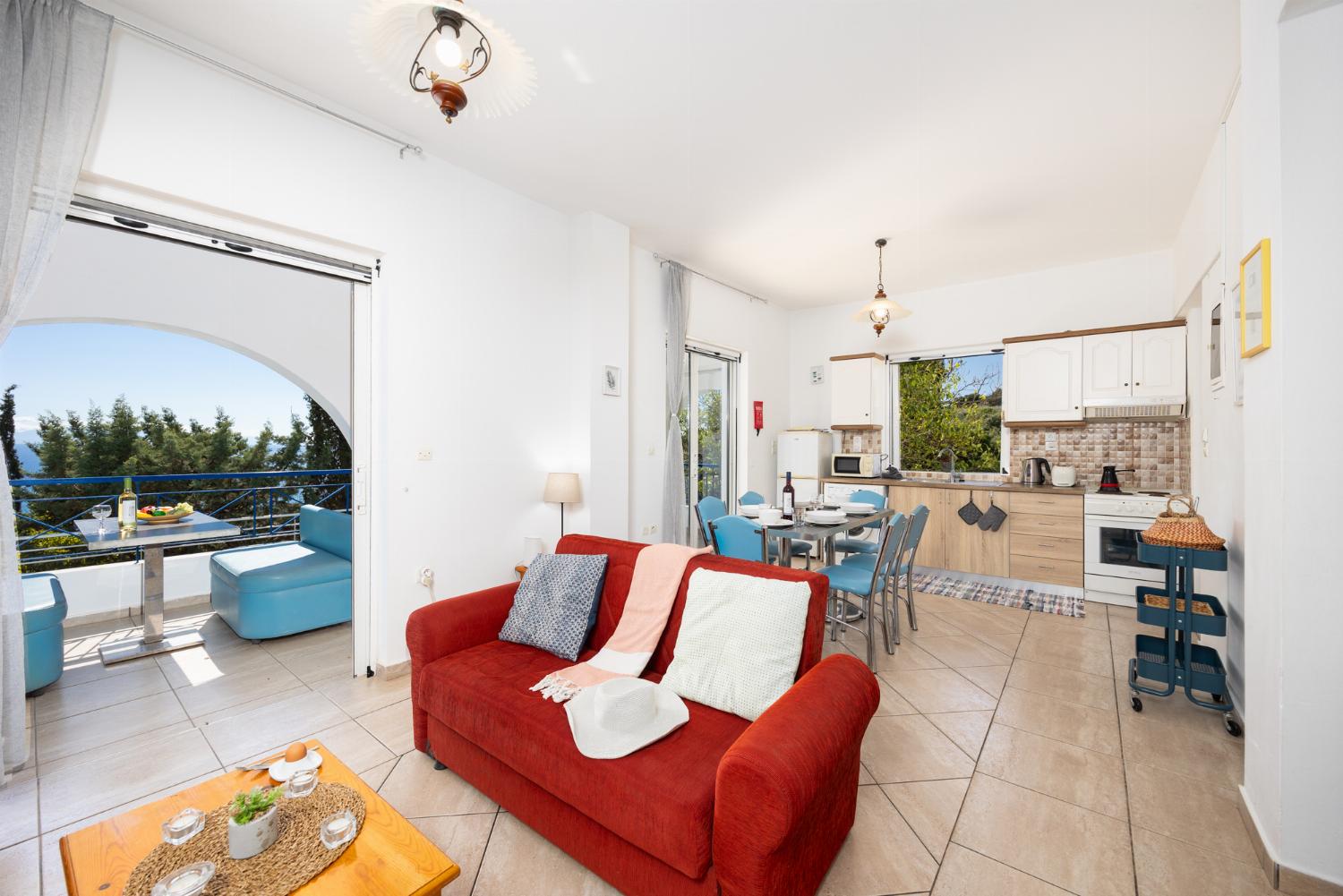 Open-plan living room with sofas, dining area, kitchen, A/C, WiFi internet, satellite TV, and sea views