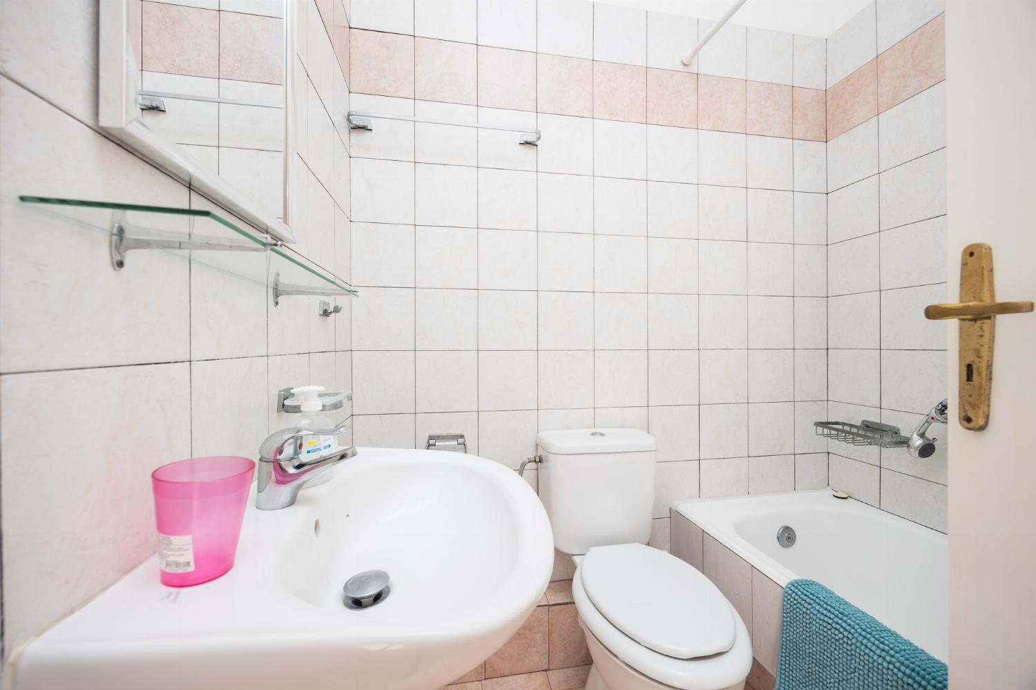 En suite bathroom with bath and shower