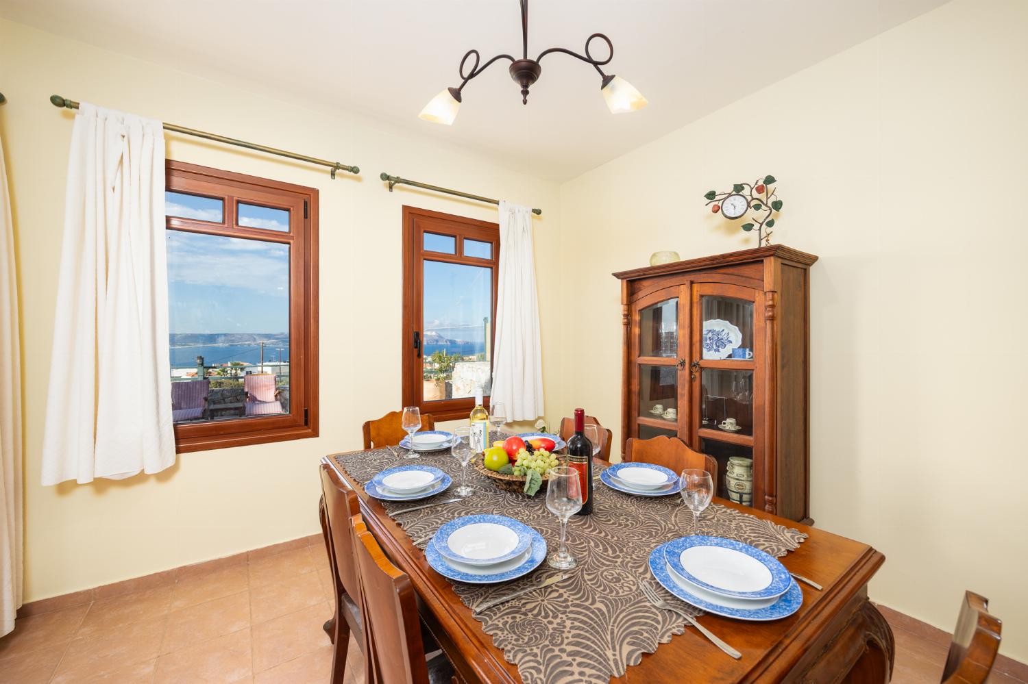 Living room with sofa, dining area, ornamental fireplace, A/C, WiFi internet, and sea views