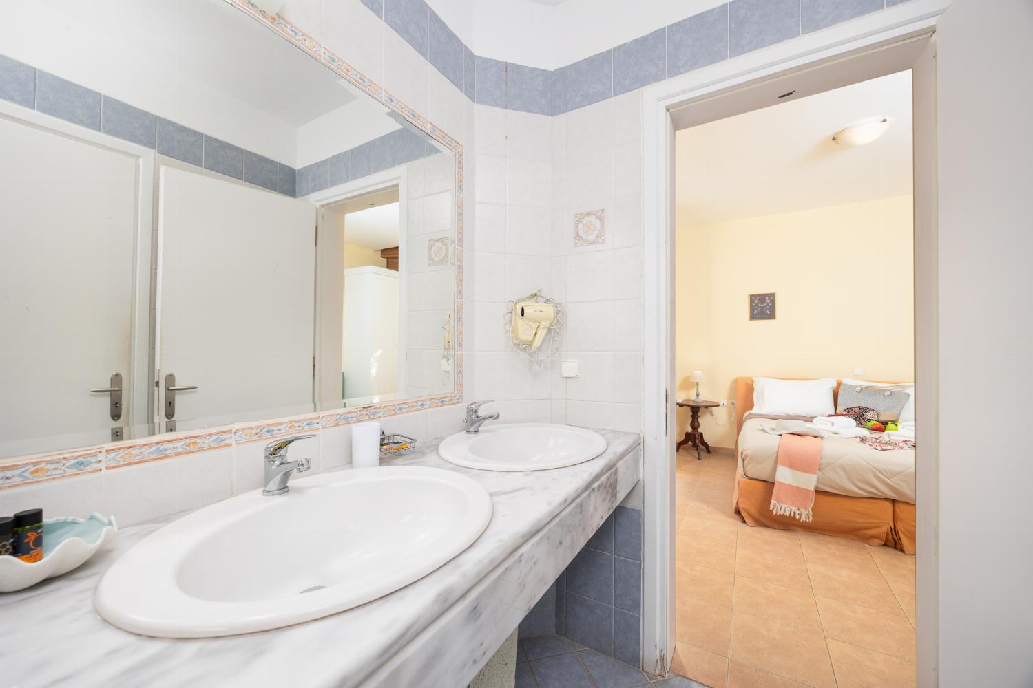 Shared en suite bathroom with bath and shower