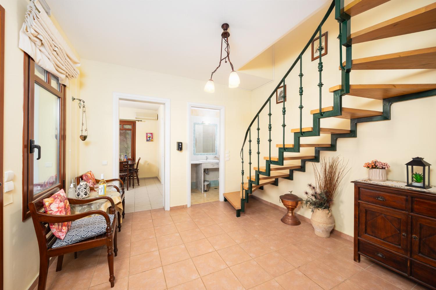 Living room with sofa, ornamental fireplace, A/C, WiFi internet, and satellite TV