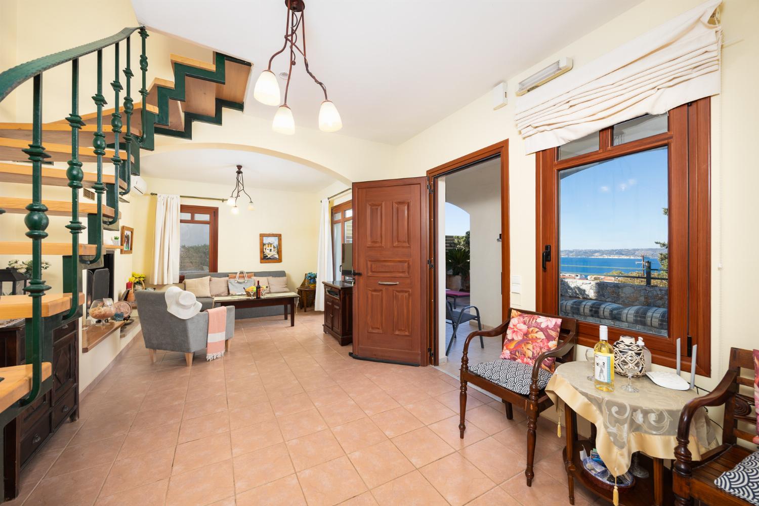 Living room with sofa, ornamental fireplace, A/C, WiFi internet, and satellite TV
