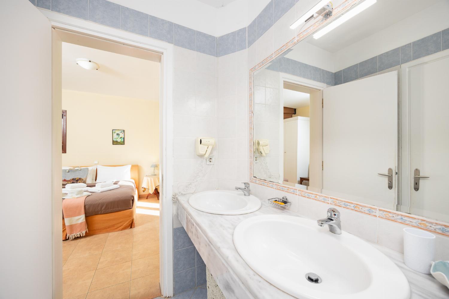 Shared en suite bathroom with bath and shower