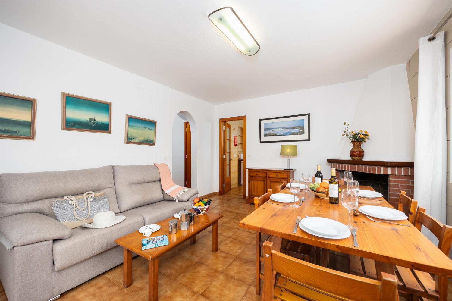 Living room with sofa, dining area, ornamental fireplace, WiFi internet, and satellite TV