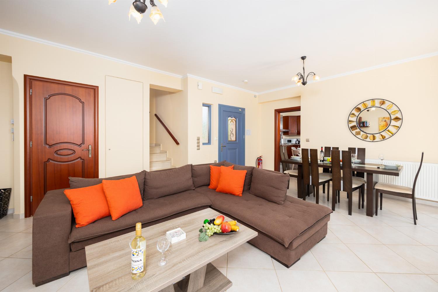 Living room with sofa, dining area, ornamental fireplace, A/C, WiFi internet, and satellite TV