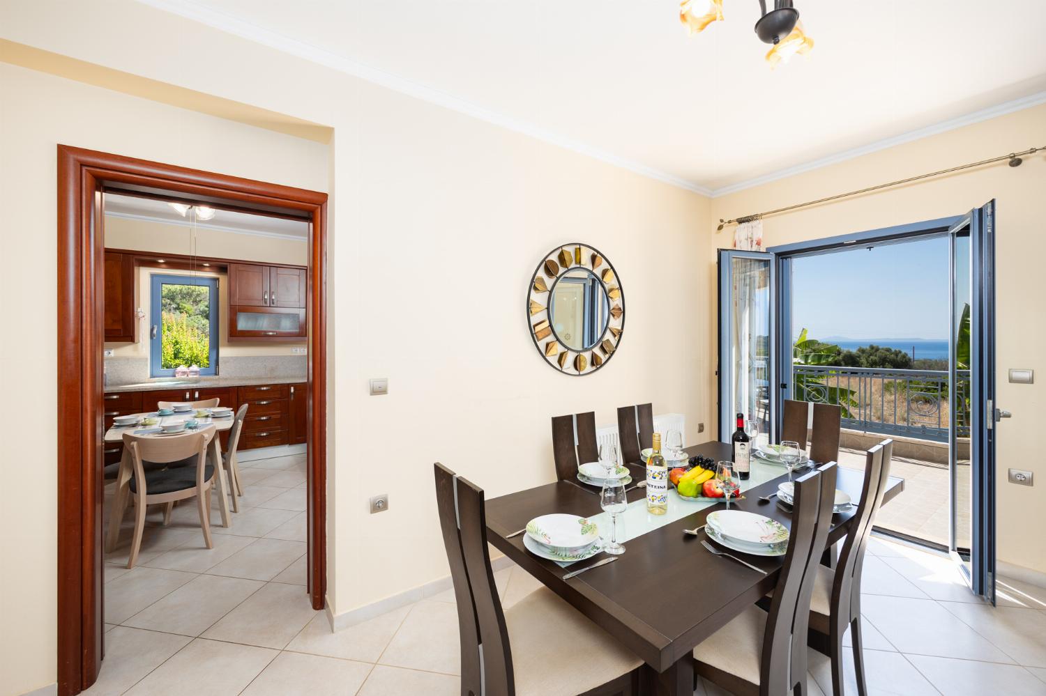 Living room with sofa, dining area, ornamental fireplace, A/C, WiFi internet, and satellite TV