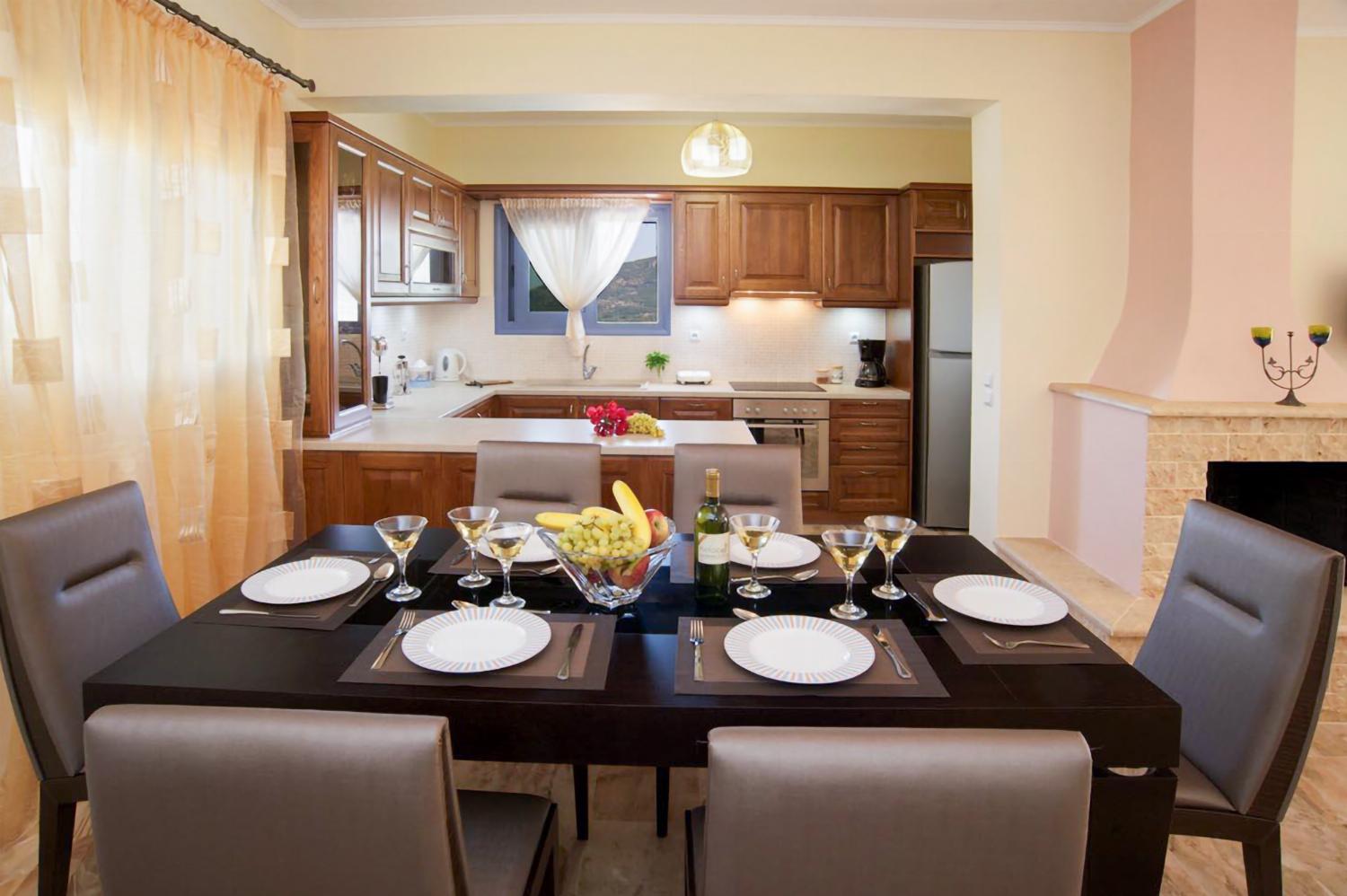 Open-plan living room with sofa, dining area kitchen, A/C, WiFi internet, and satellite TV