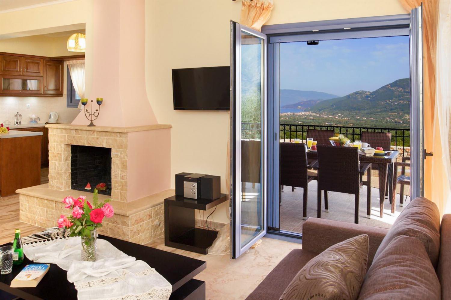 Open-plan living room with sofa, dining area kitchen, A/C, WiFi internet, and satellite TV