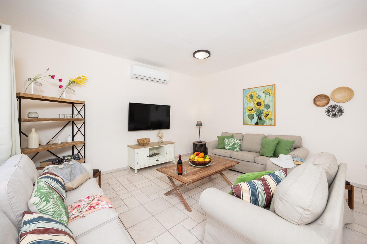 Living room with sofas, A/C, WiFi internet, and satellite TV