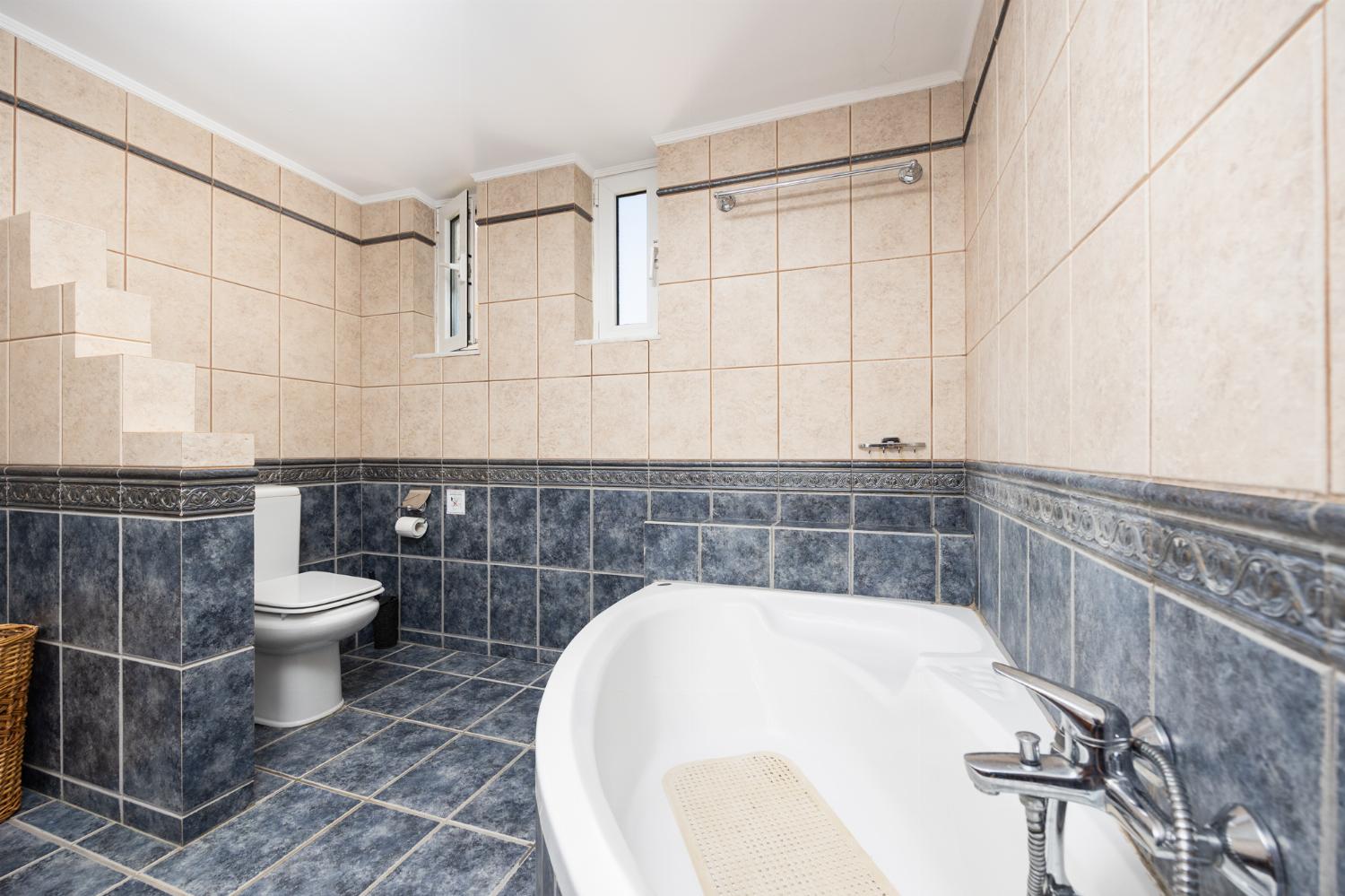 Family bathroom with bath and shower