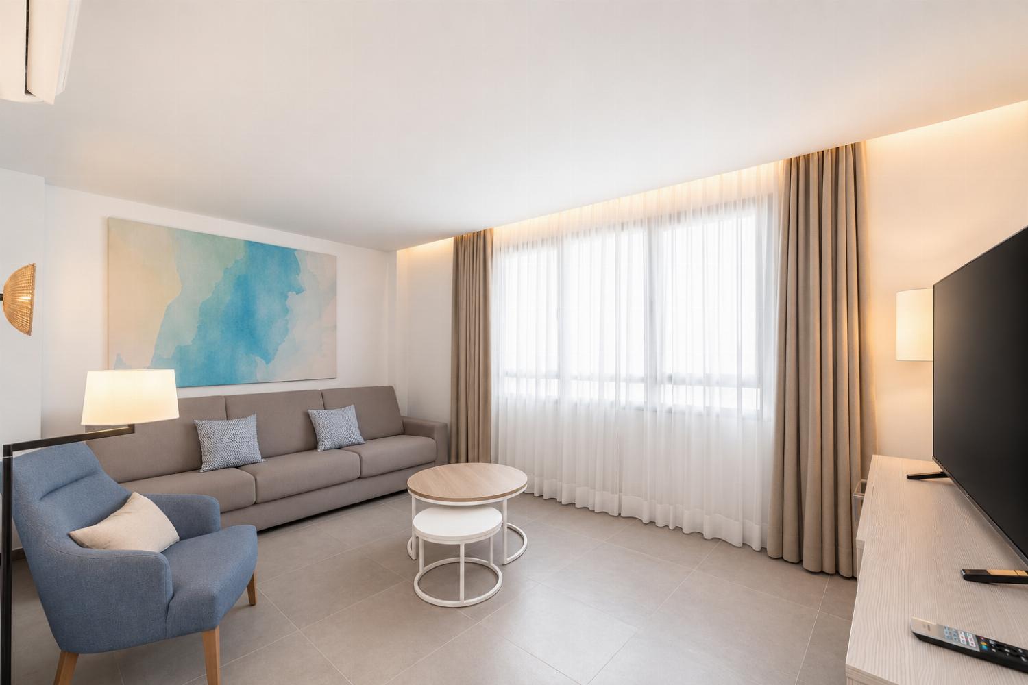 A bright modern living room with elegant neutral decor.